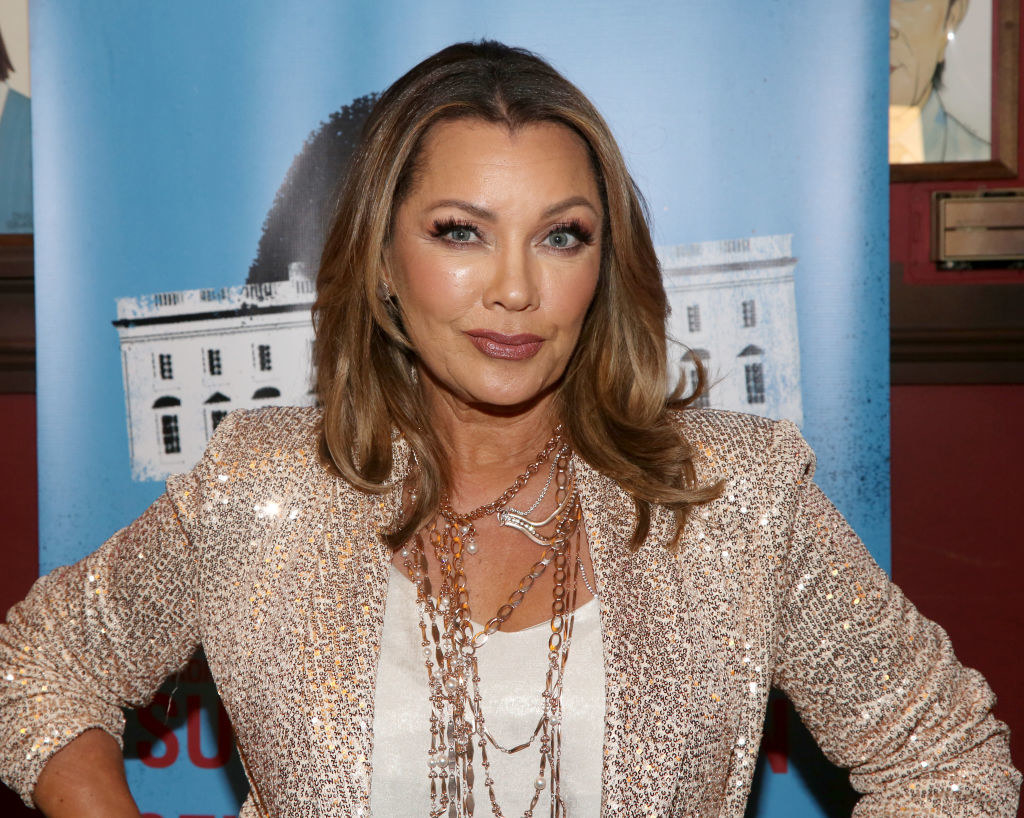 Vanessa Williams smiling with her hands on her hips