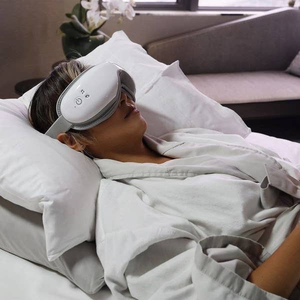 a person lying down wearing the eye mask