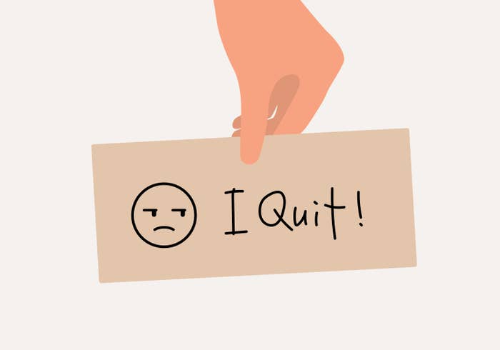 An illustration of a hand holding a piece of paper that says &quot;I Quit!&quot;