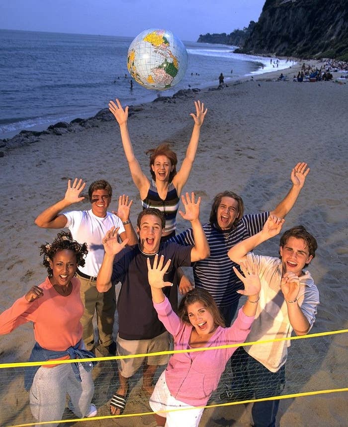 Boy Meets World cast on a sandy beach waving