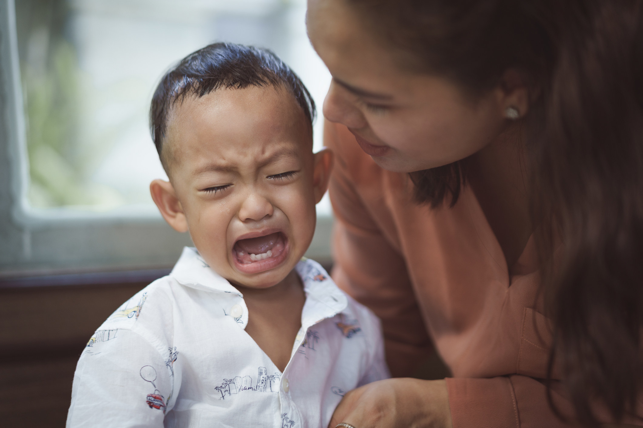 A woman with a crying child