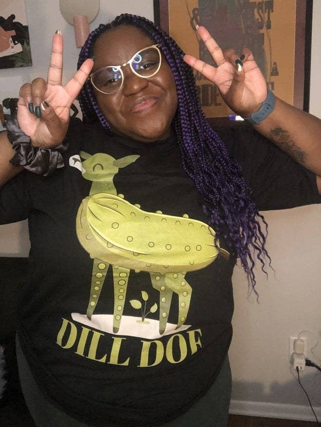 Photo of black woman with purple braids in t-shirt that says &quot;dill doe&quot; with a deer made of pickles