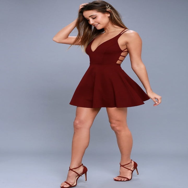 Different model posing in the red dress with heels
