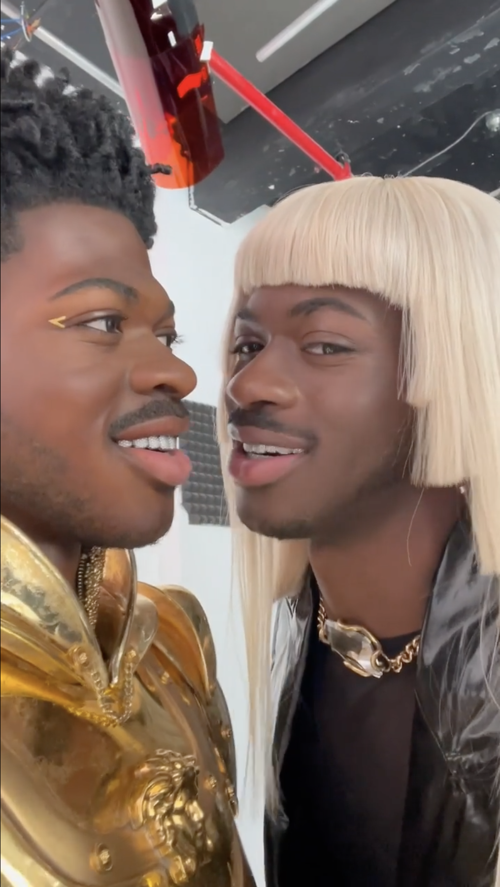 Lil Nas X in a blonde wig and face-to-face with his wax figure