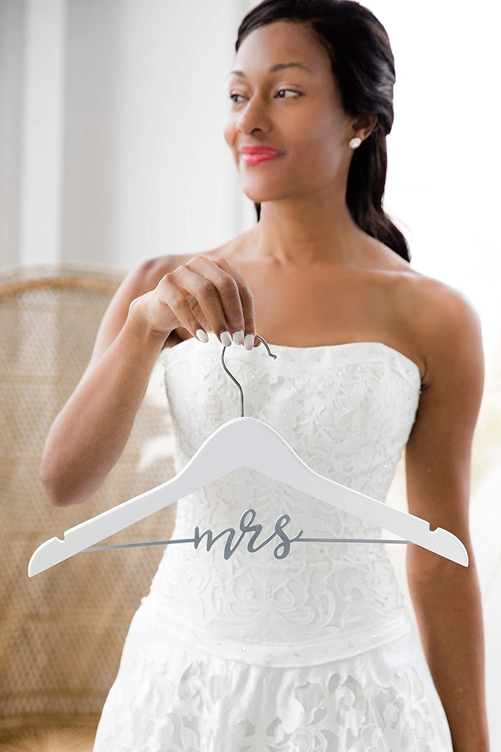 bride holding up the mrs hanger