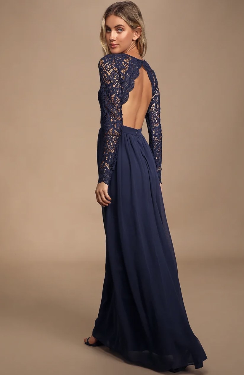 Model looking over shoulder in navy blue dress