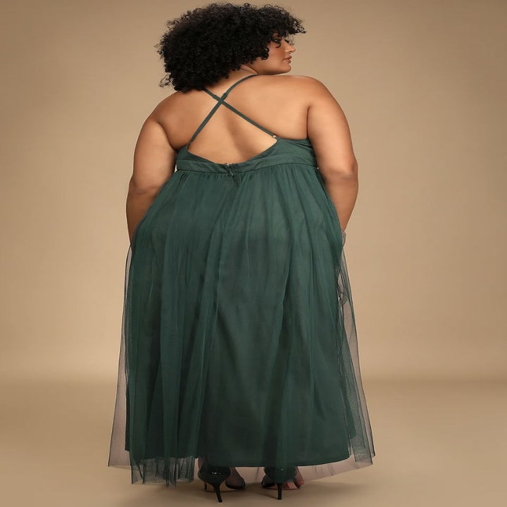 Model from back in the green maxi dress