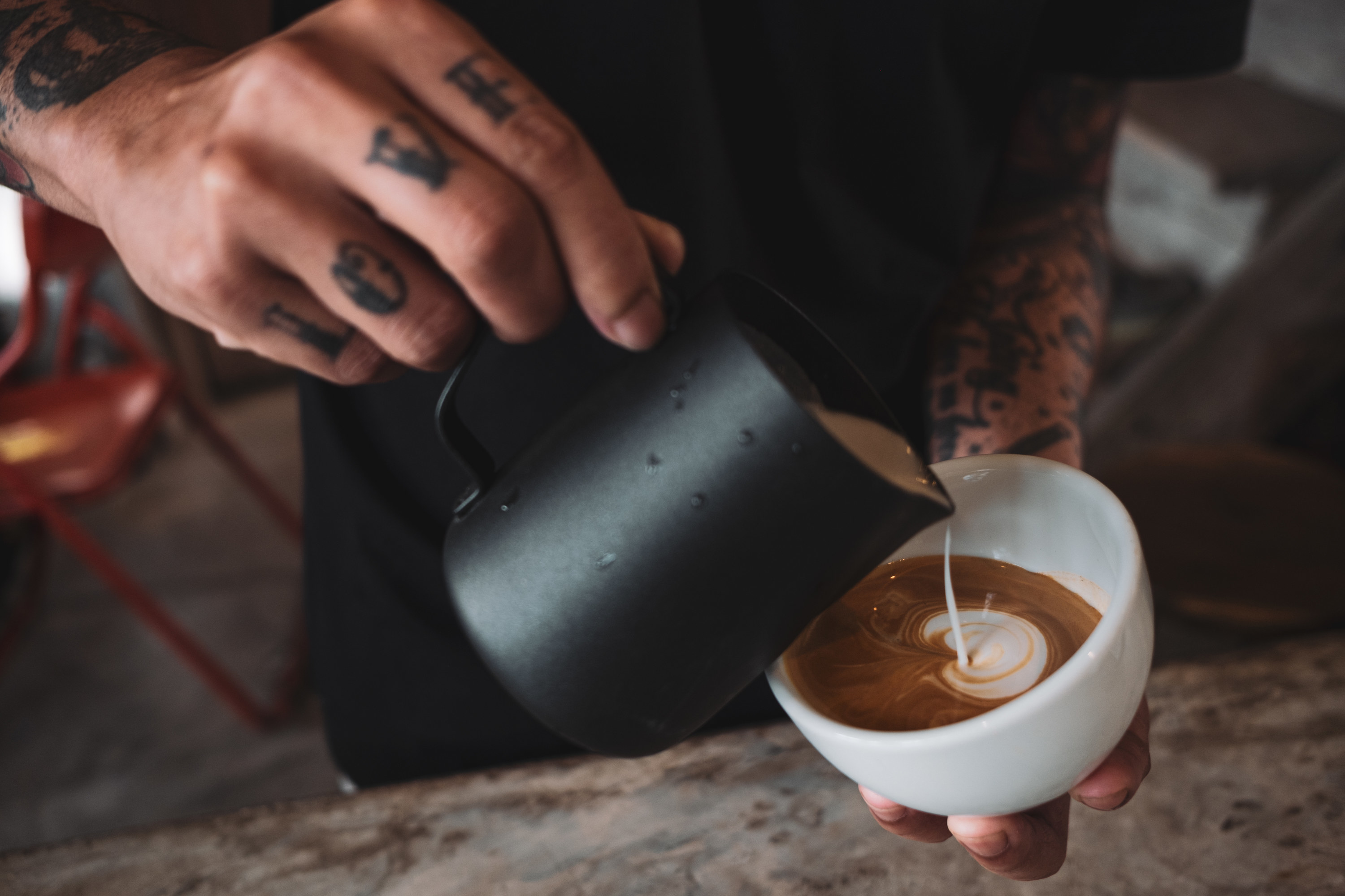 barista making a latte