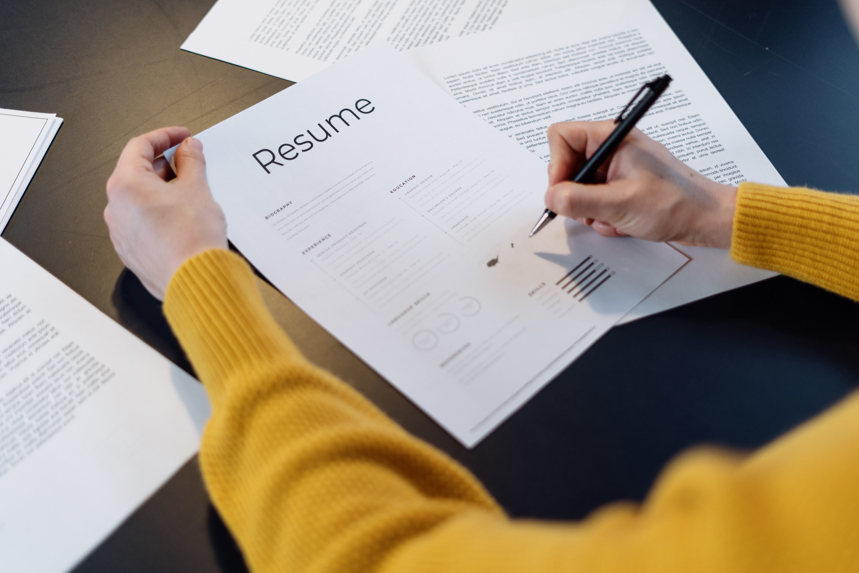woman making notes on a resume