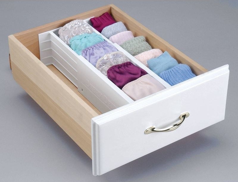 a drawer divided into three compartments with underwear and socks inside