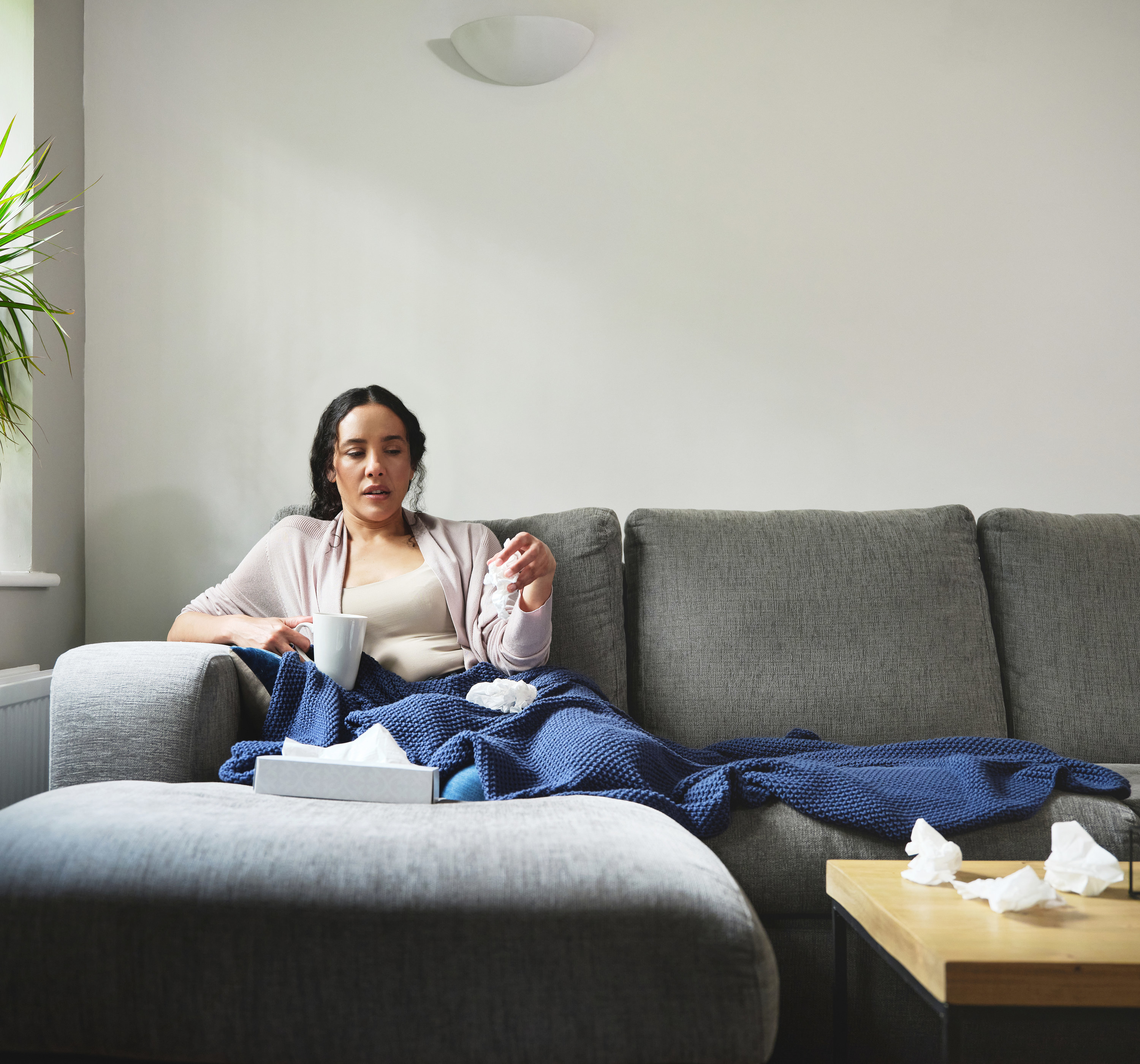 sick woman resting on her couch