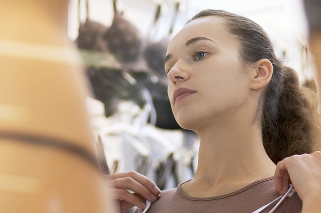 A woman looks at bras at a lingerie shop
