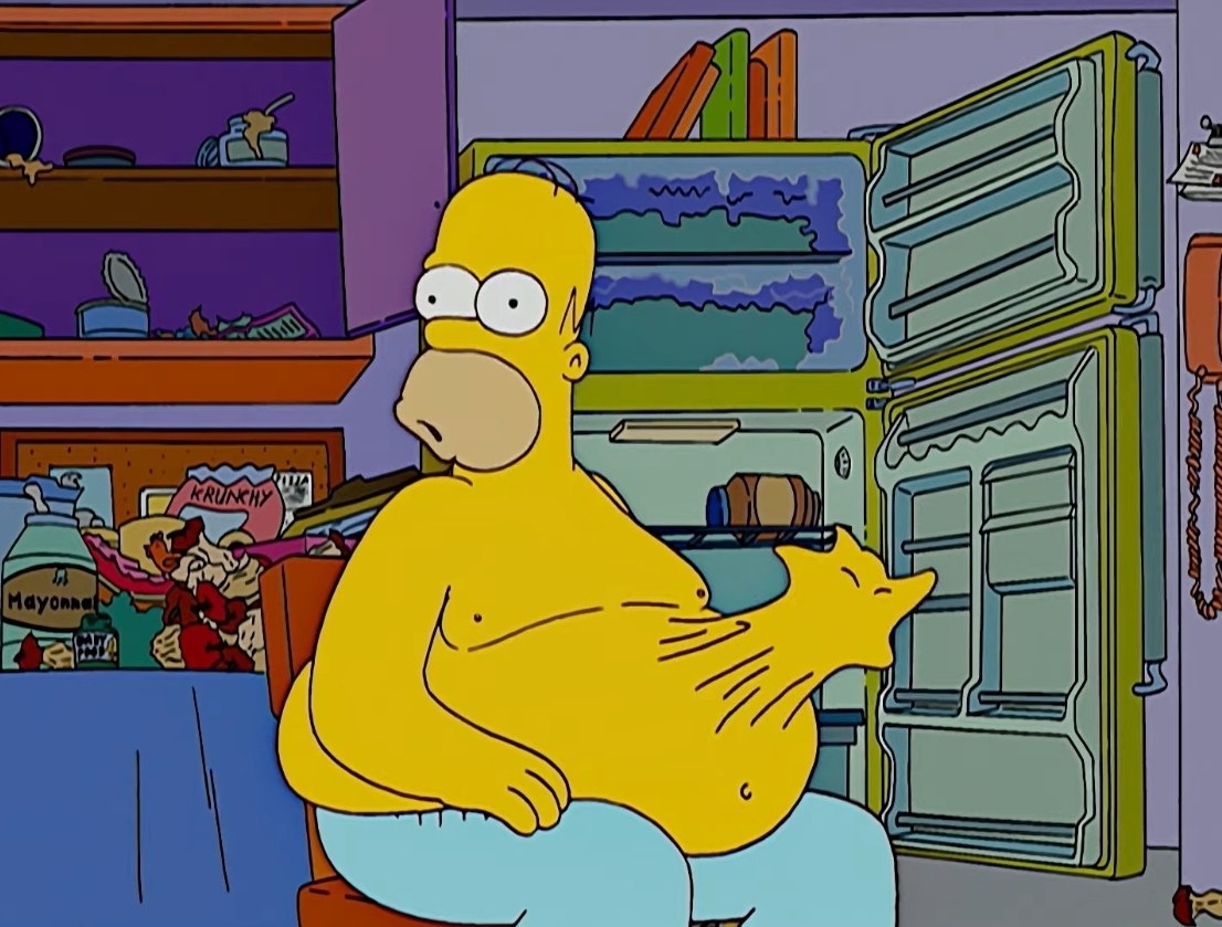 Homer sits in front of an open fridge and a hand inside his stomach reaching out