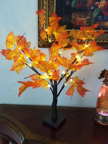 Faux fall tree placed on table