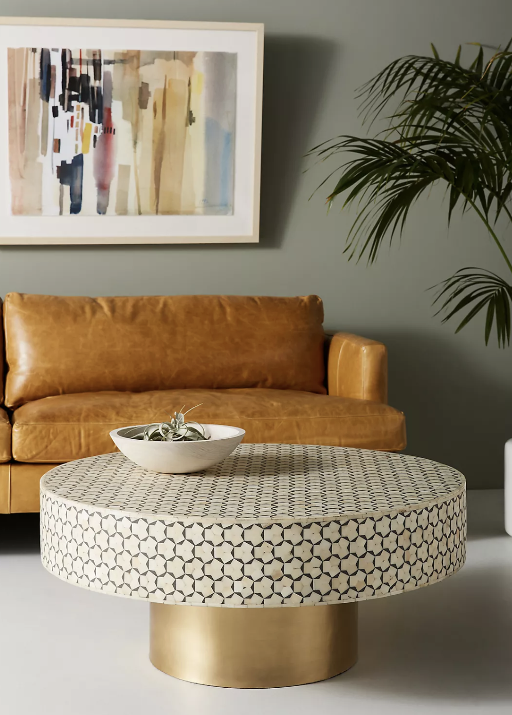 the coffee table with a gold-tones base and patterned table