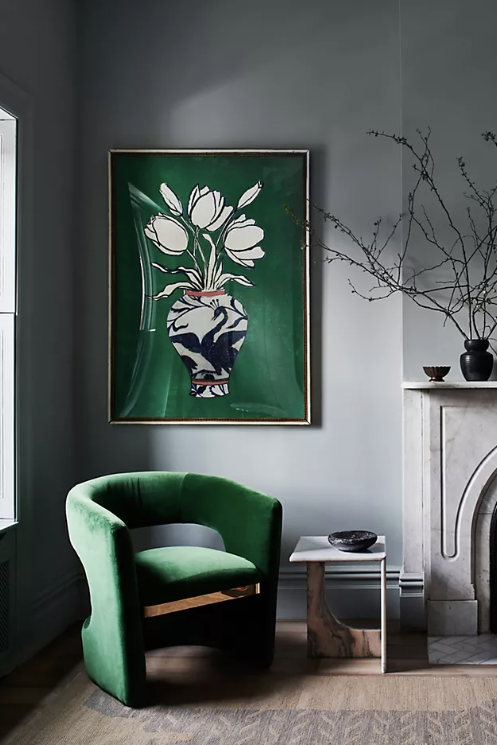 the green art piece with flowers in a vase hanging on a wall