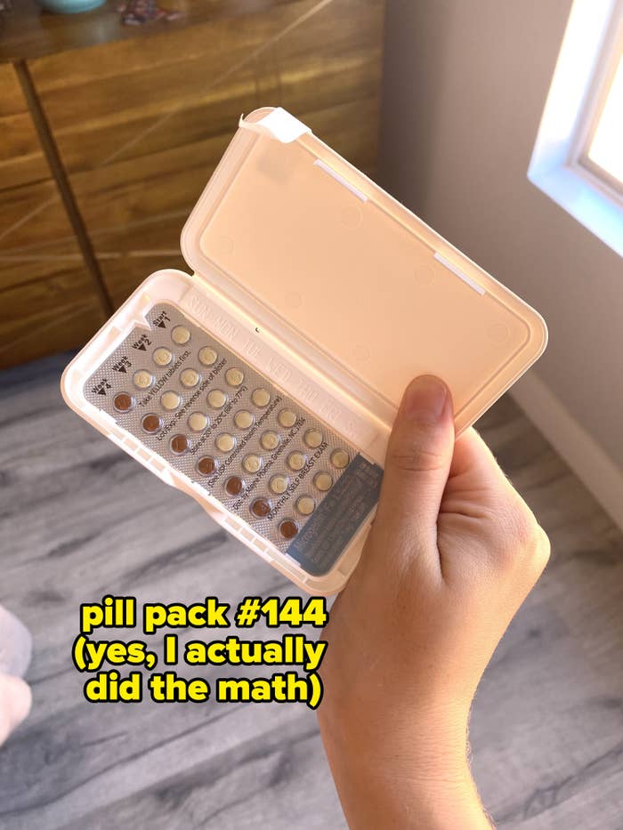 The writer holding a pack of birth control pills labeled &quot;pill pack #144 (yes, I actually did the math)&quot;