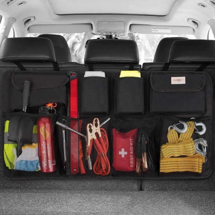 the trunk organizer hanging over the back seats of a car