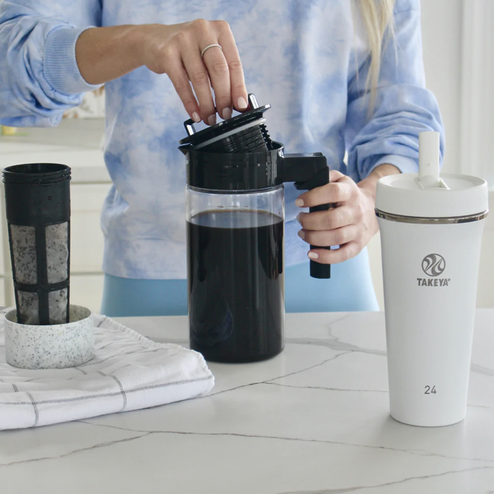 a model using the coffee maker with the filter next to the fine-mesh coffee filter