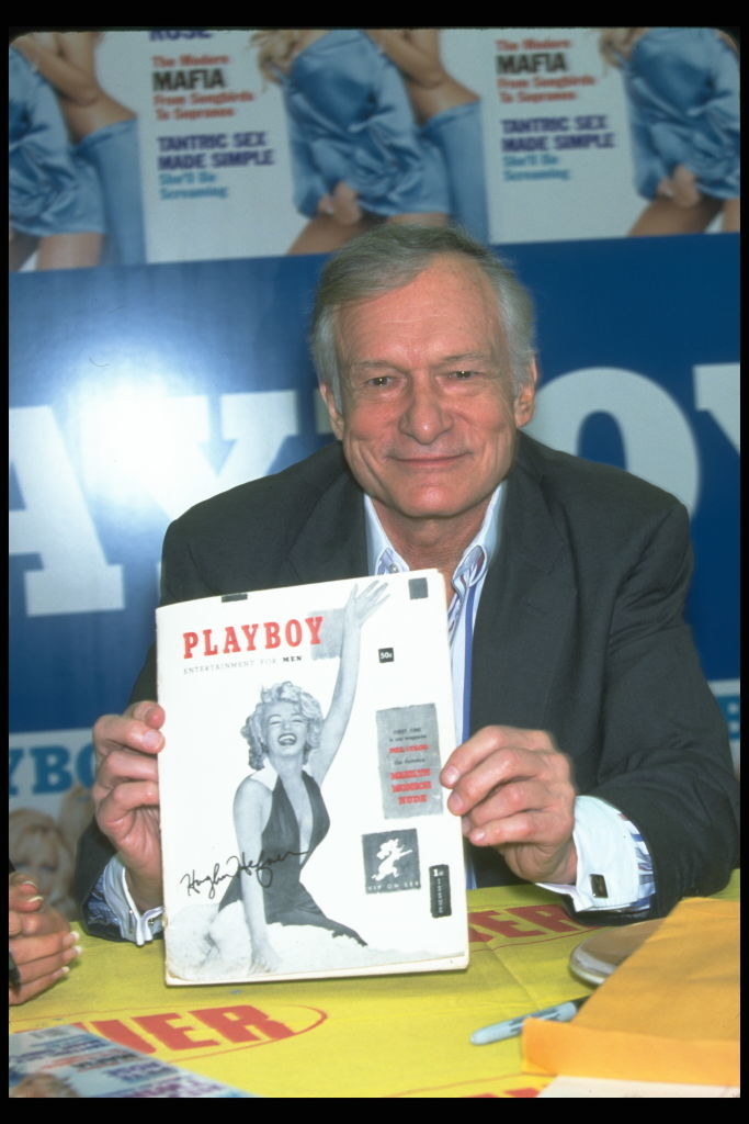 Hugh Hefner holding a Playboy with Marilyn Monroe on the cover