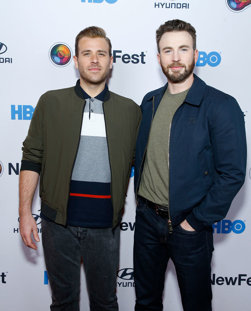 Scott and Chris Evans standing together at a step-and-repeat