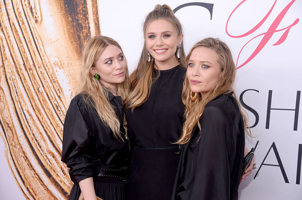 the Olsen twins with their younger sister