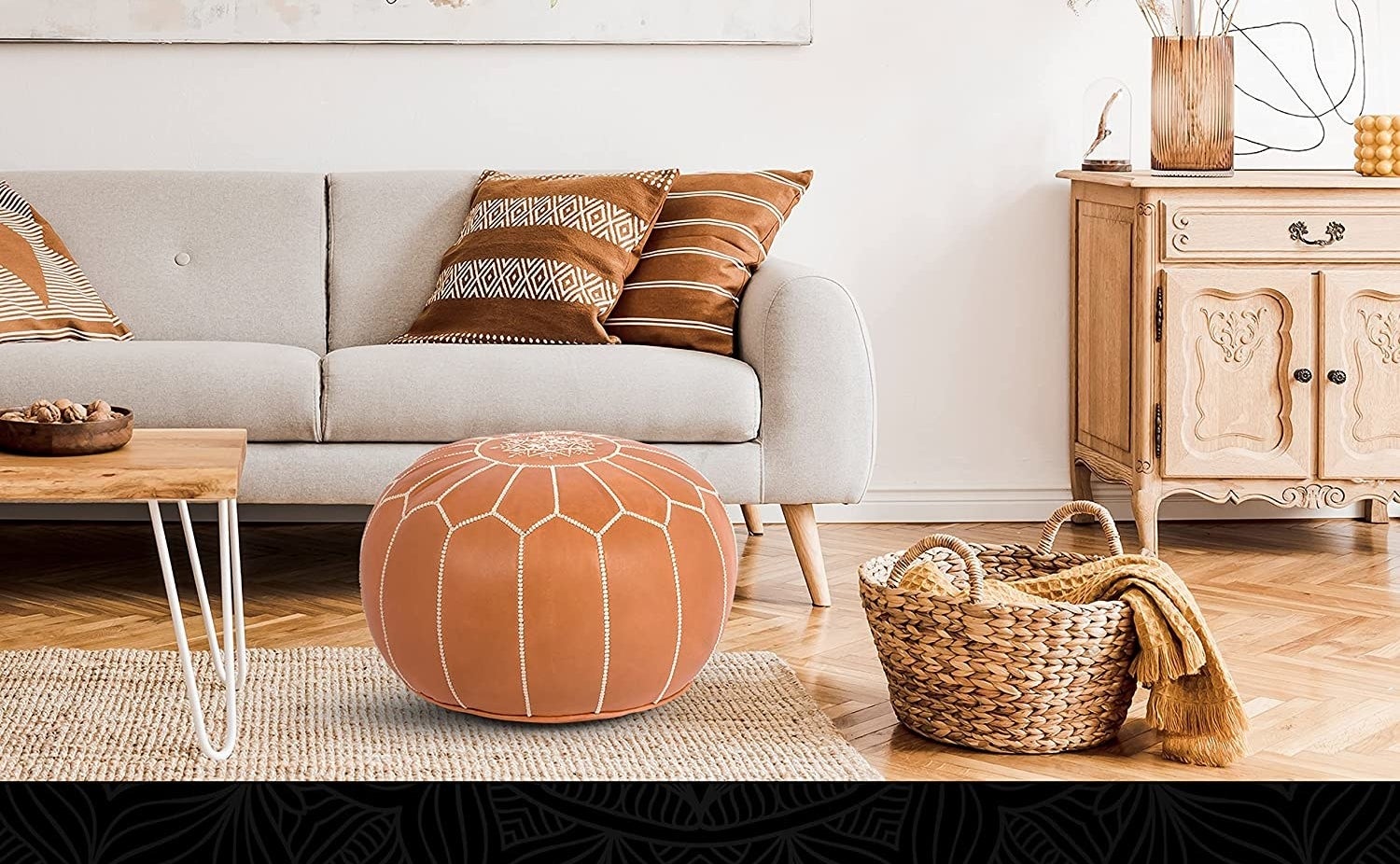 the pouf in a living room by a couch and basket