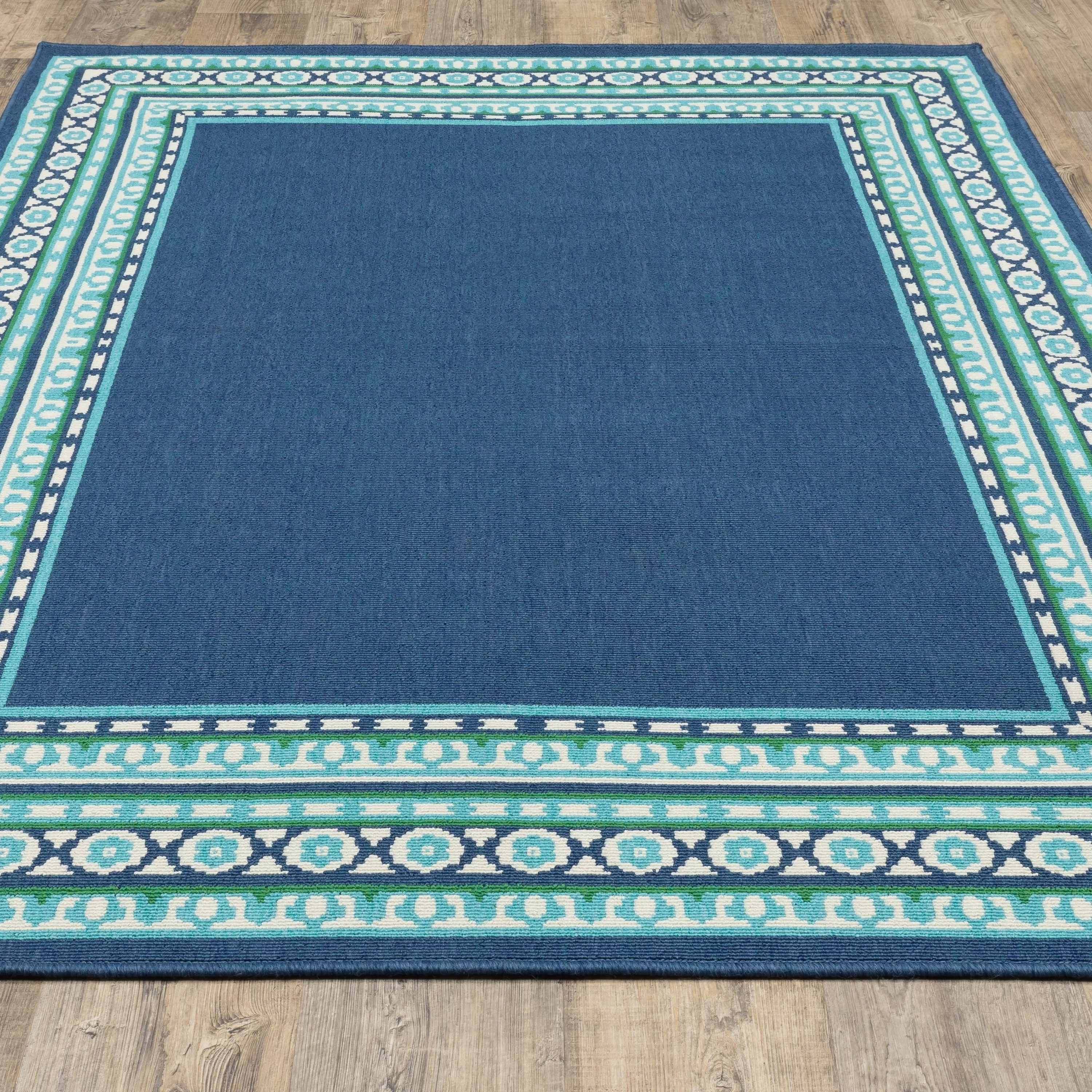 a turquoise and blue southwestern rug on a hardwood floor