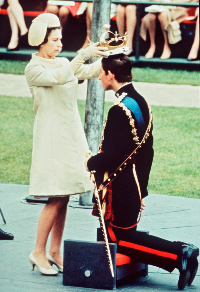 the Queen putting a crown on the Prince as he kneels