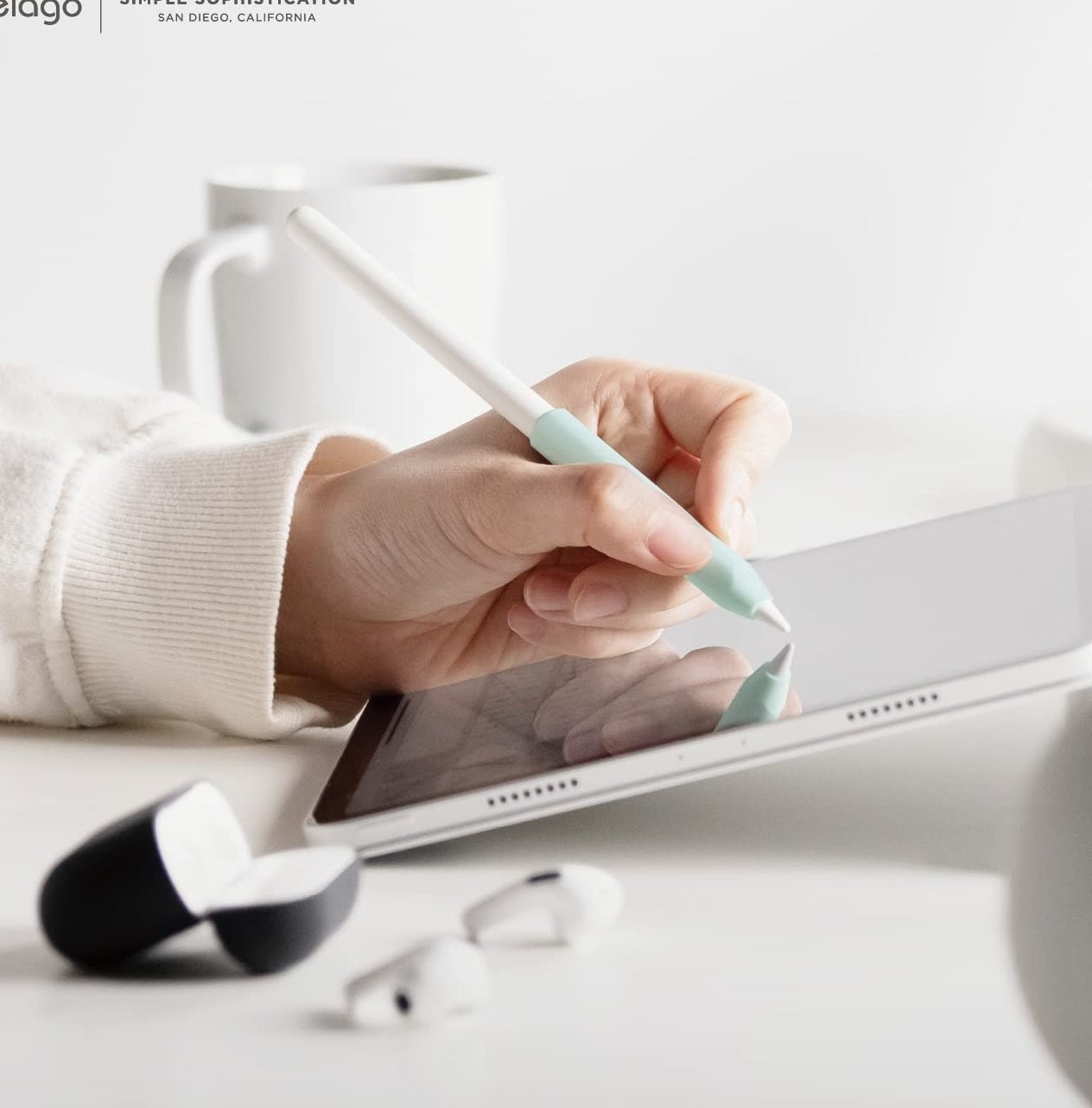 A person using their Apple Pencil with a grip on it