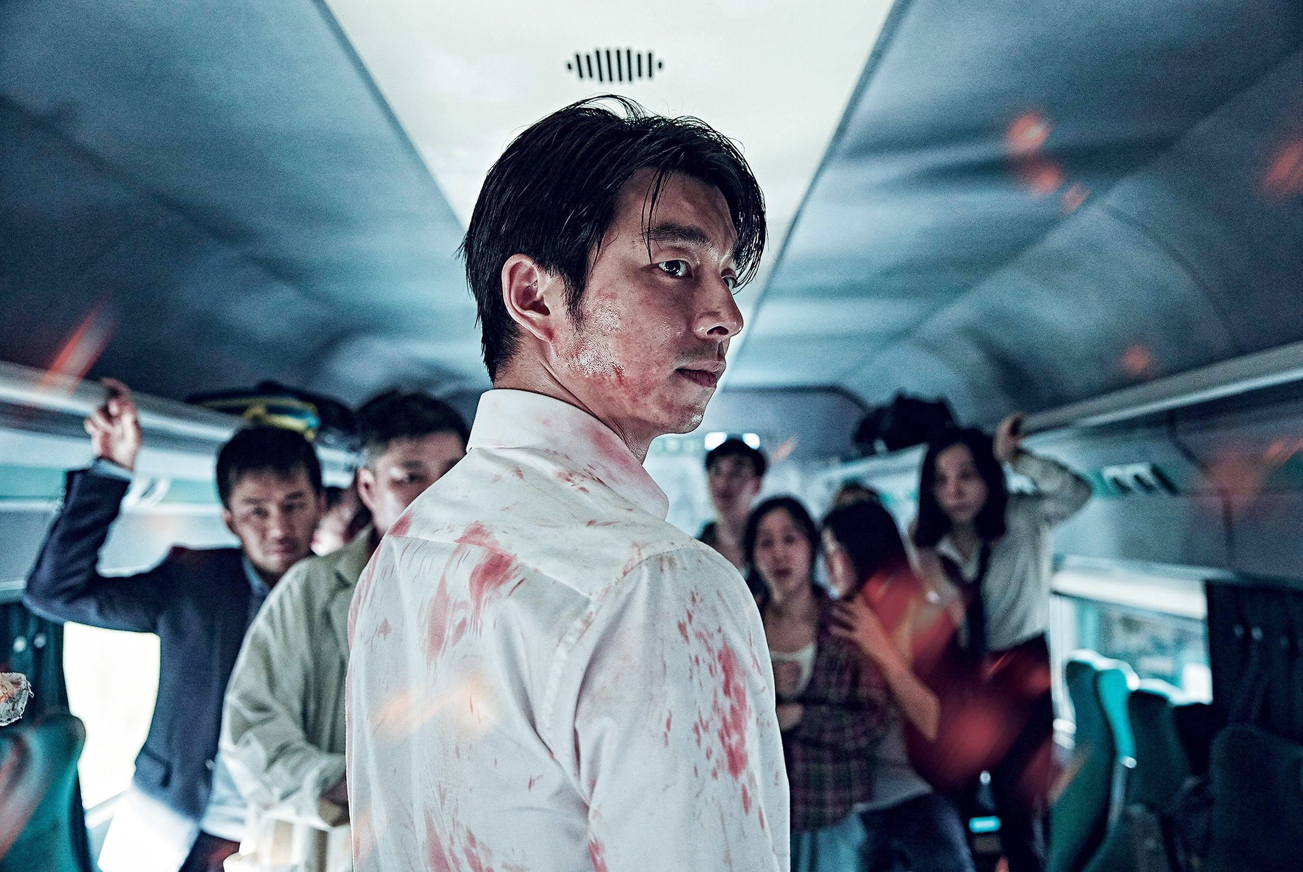 Gong Yoo looks over his shoulder while covered in blood