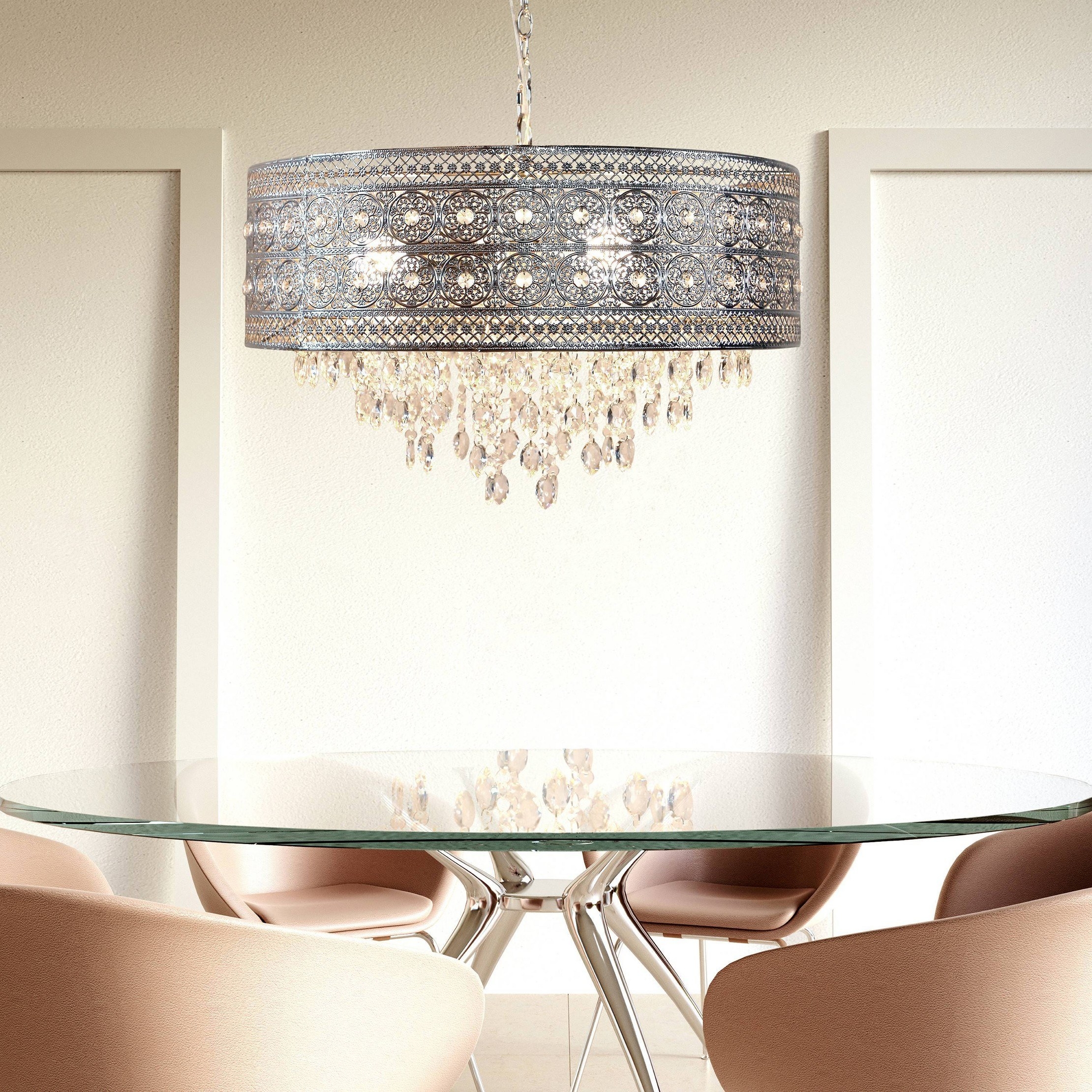 the polished nickel and crystal chandelier hanging over a glass dining table