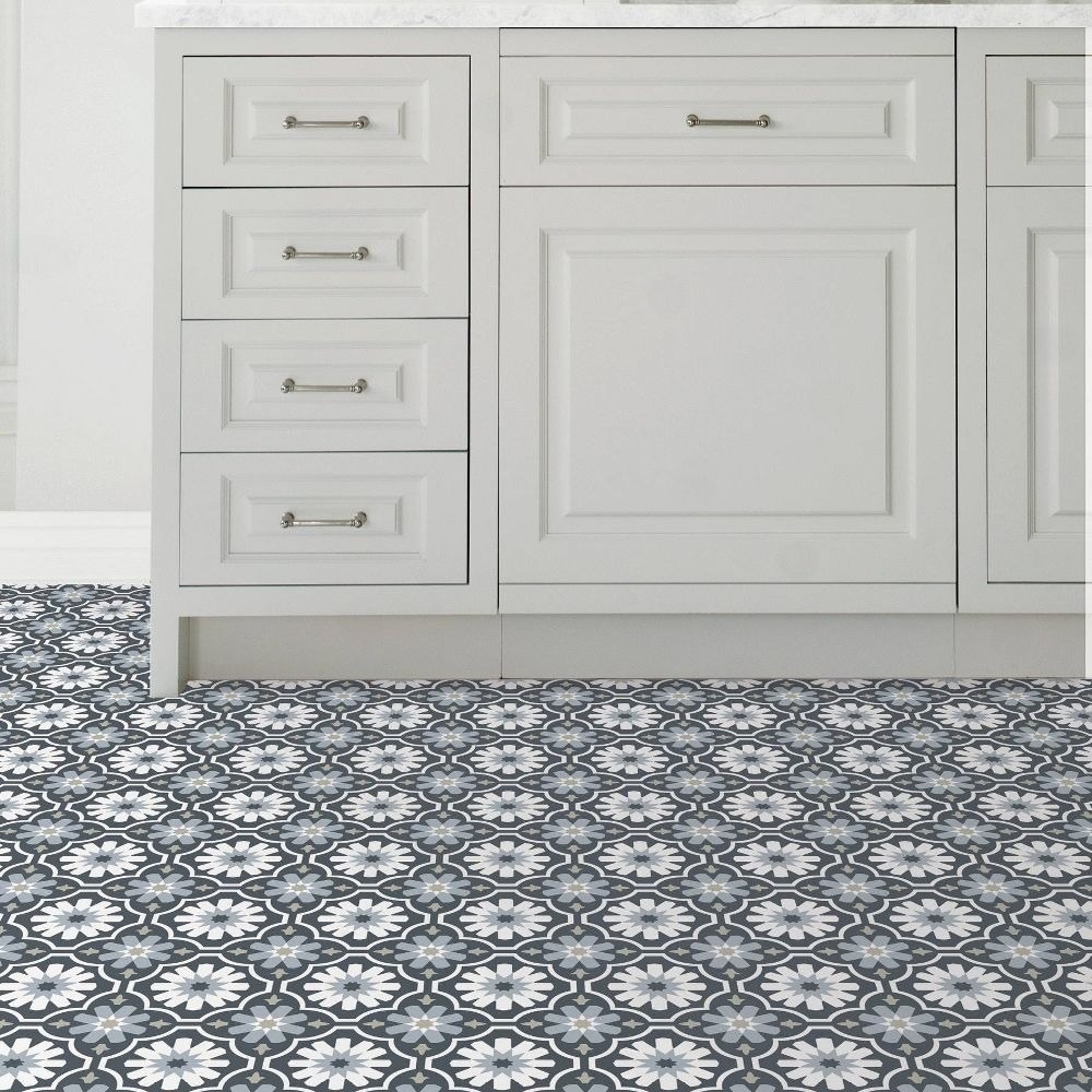 the Moroccan-style tiling on a floor by a white cabinet