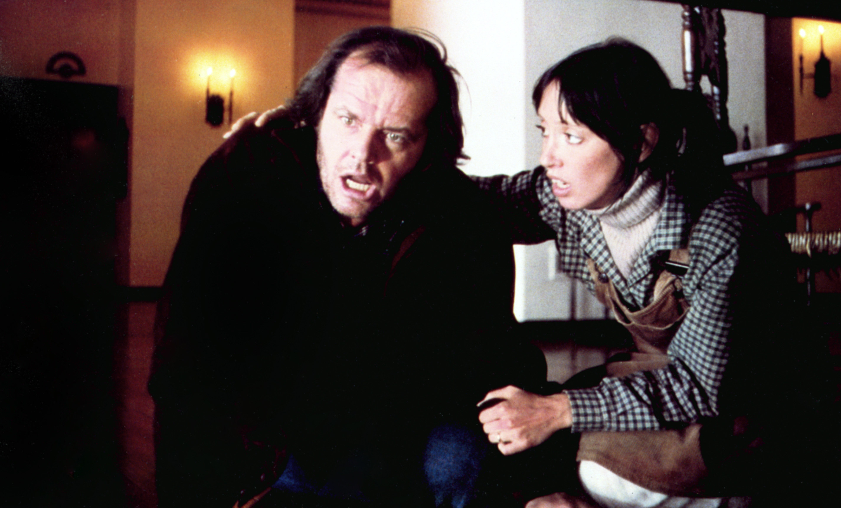 Jack Nicholson and Shelley Duvall crouch on the floor