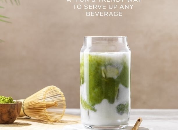 the glass with matcha and cream in it