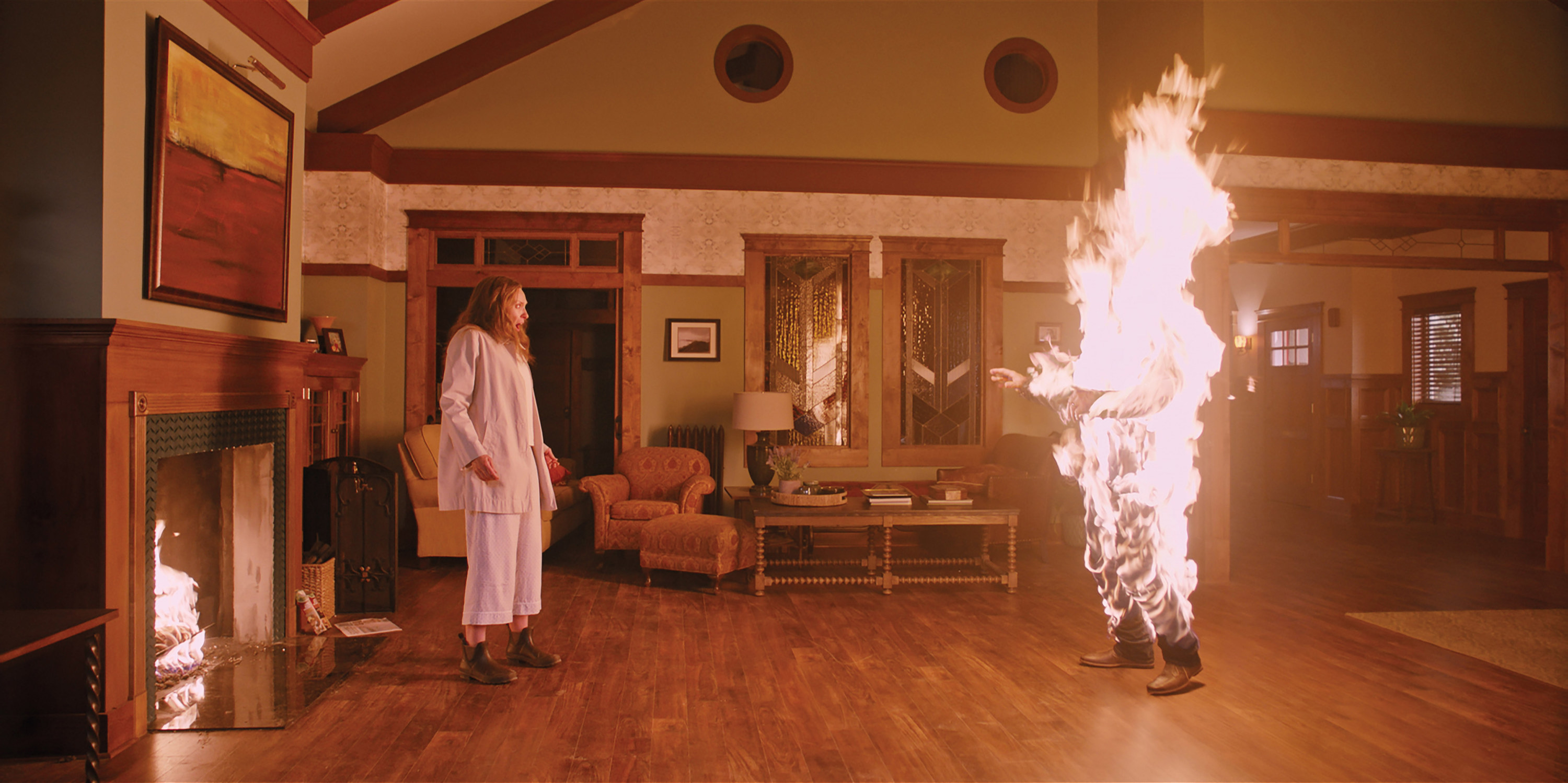Toni Collette looks at a burning human in her living room