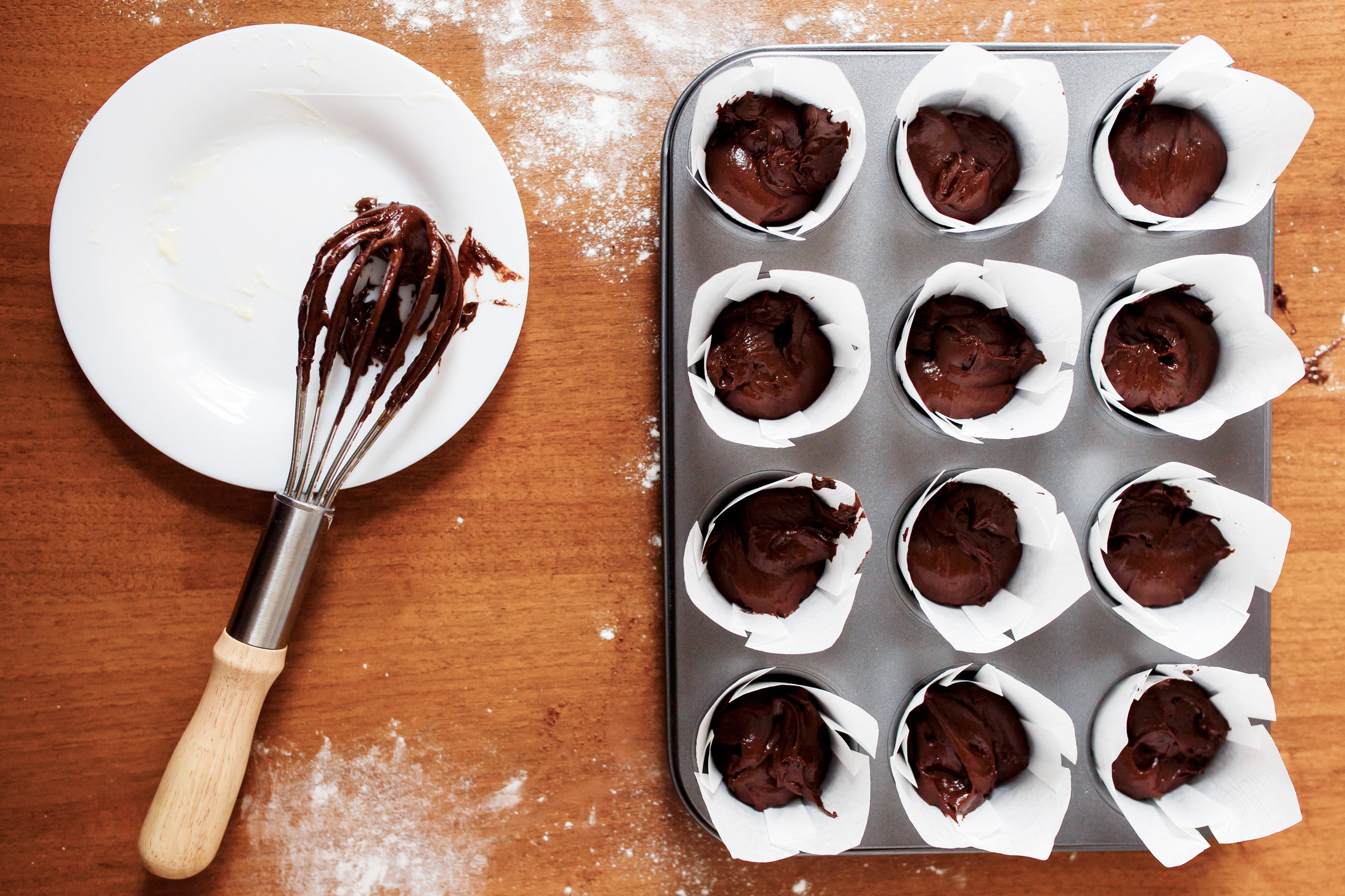 Chocolate cupcake batter in muffin tin.