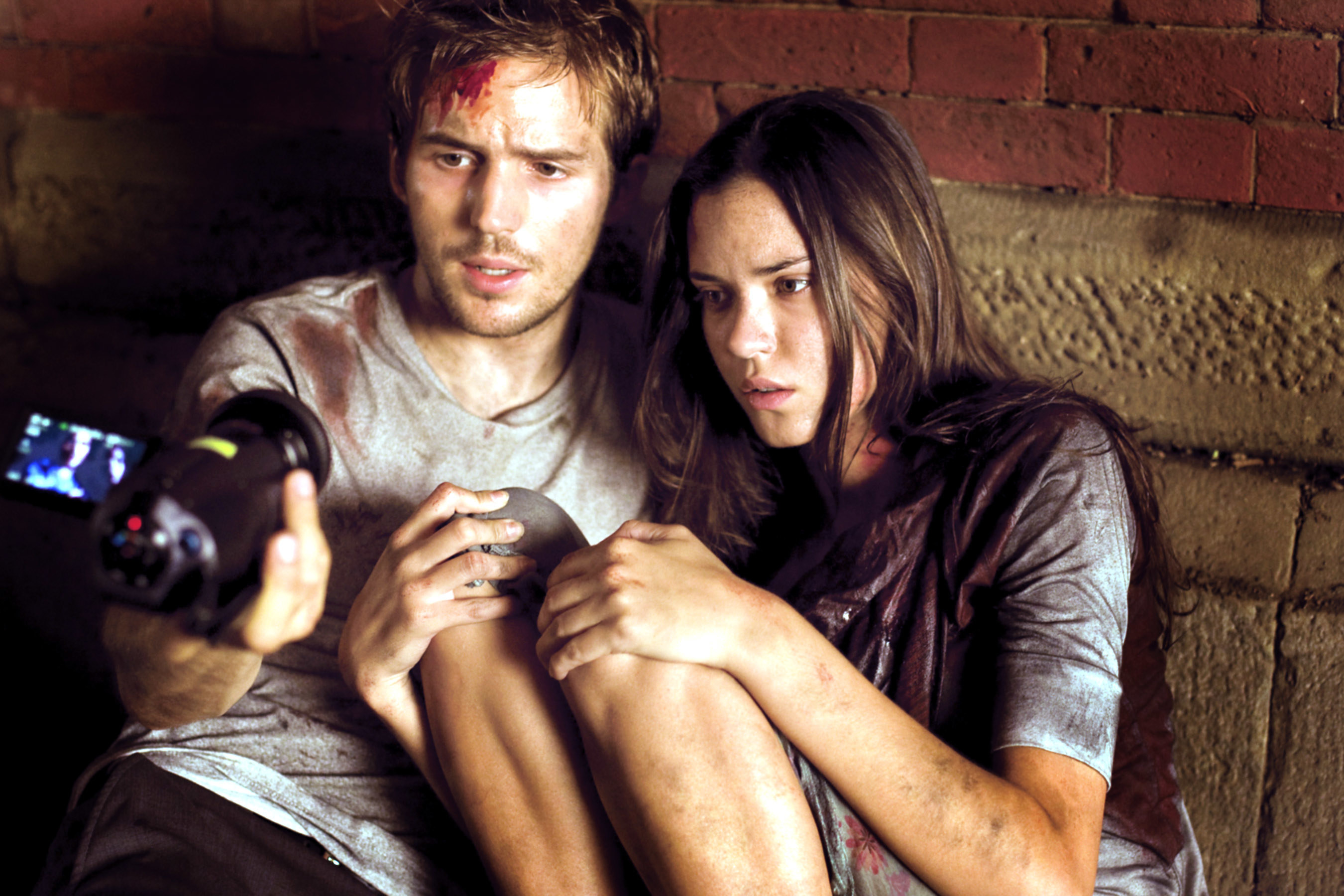 Michael Stahl-David and Odette Yustman look into a camera