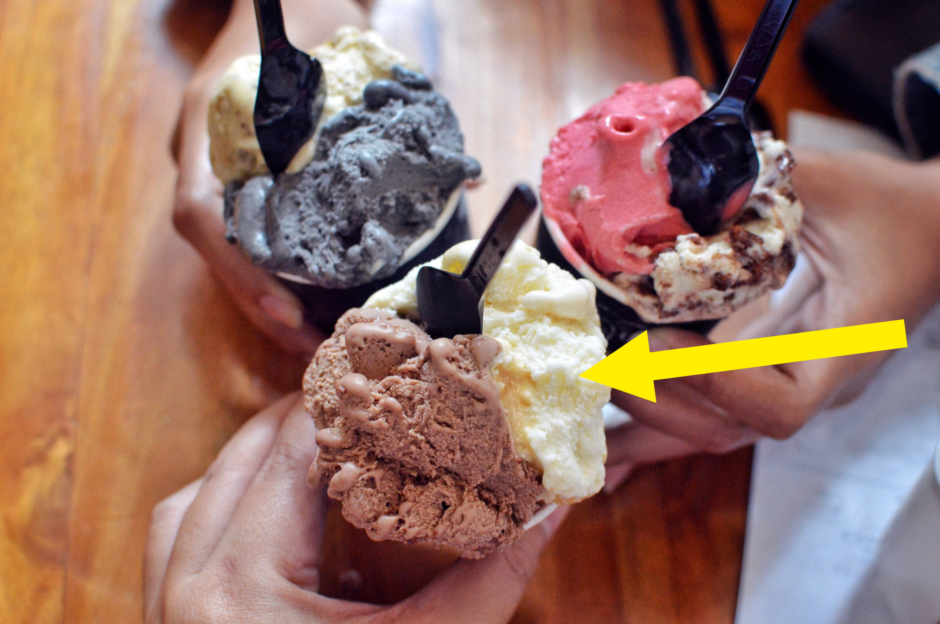 Different flavors of ice cream in cups.