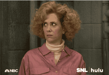 Kristen Wiig in character on SNL making an expression that says yikes