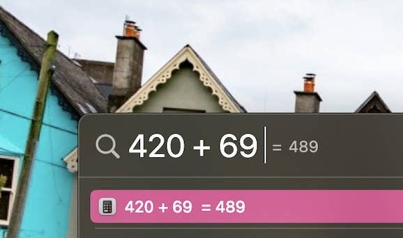 screenshot of the spotlight function on a macbook adding up 420 and 69 to equal 489