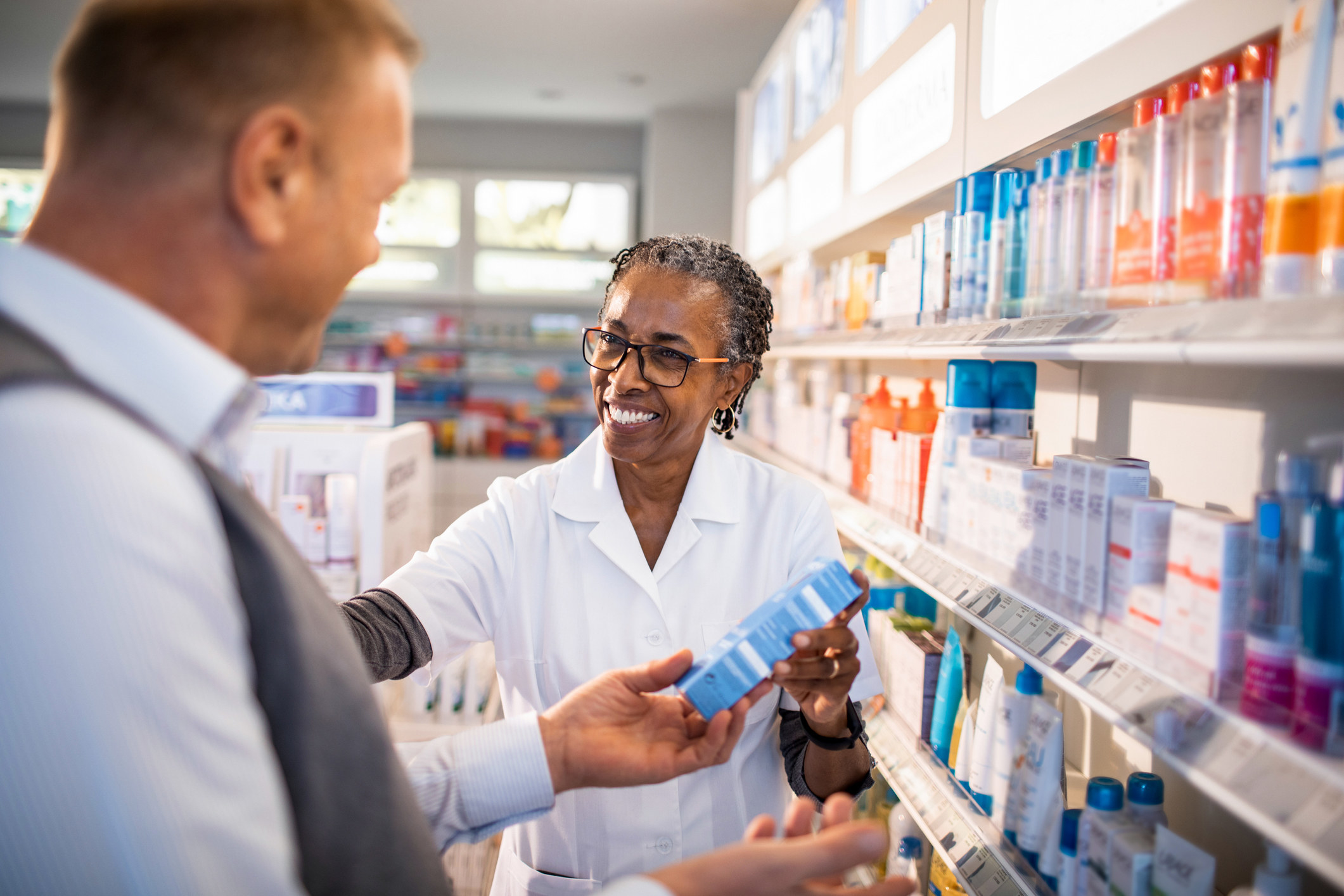 A pharmacist with a customer