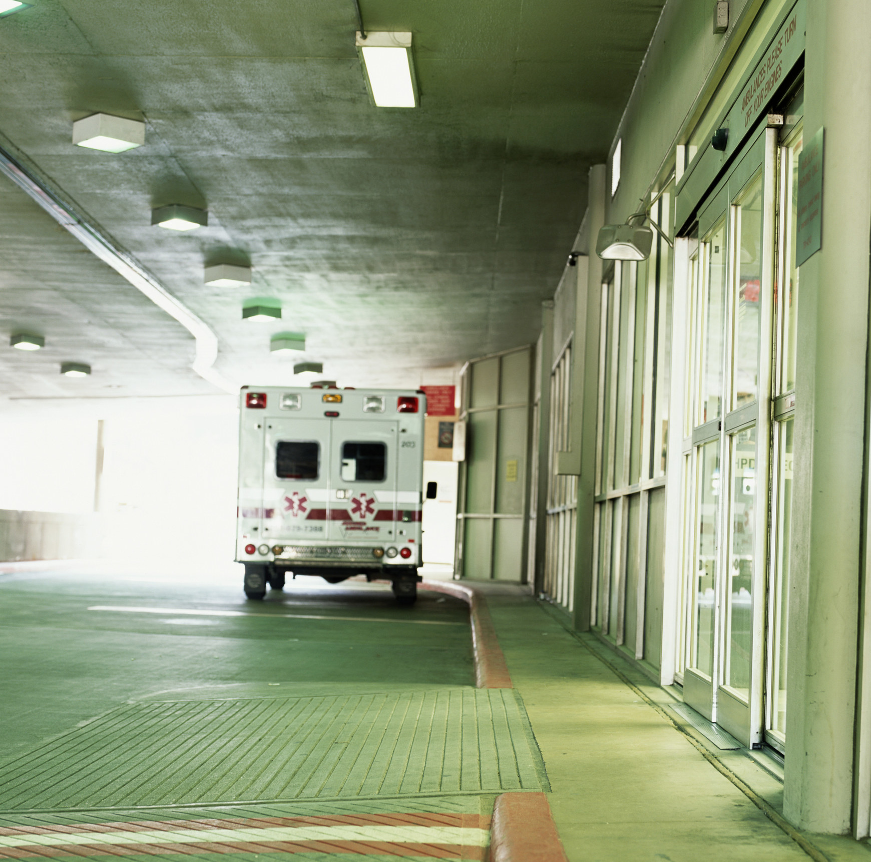 An ambulance truck parked in a hospital entryway