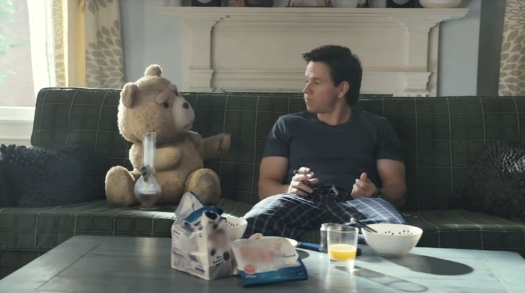 Mark Wahlberg and Ted sitting on a couch