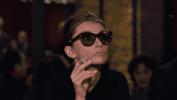 Audrey Hepburn pulling down her sunglasses and saying &#x27;gracious&#x27;