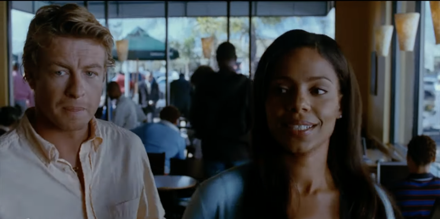 Simon Baker and Sanaa Lathan at a coffee shop.