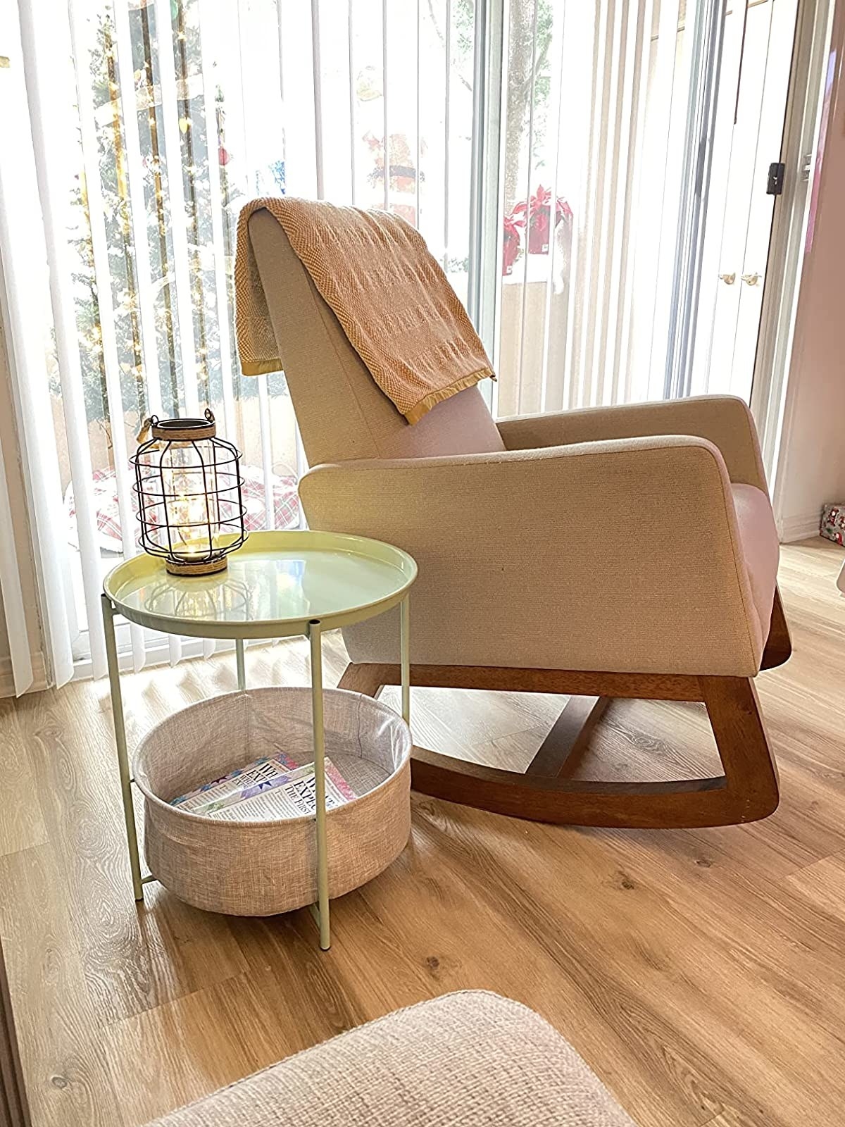 Reviewer image of side table next to a glider in a nursery