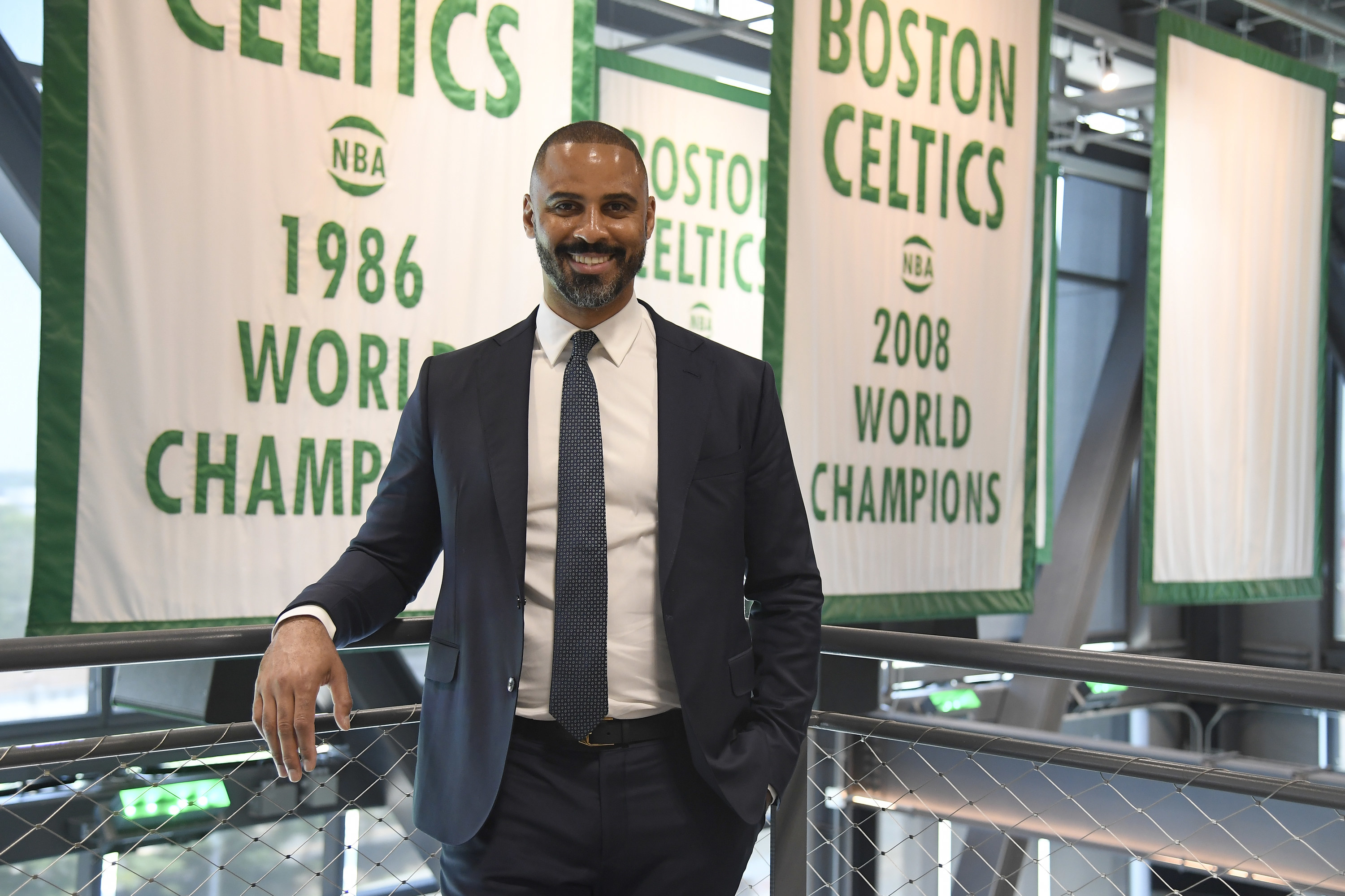 Ime poses in front of Celtics banners
