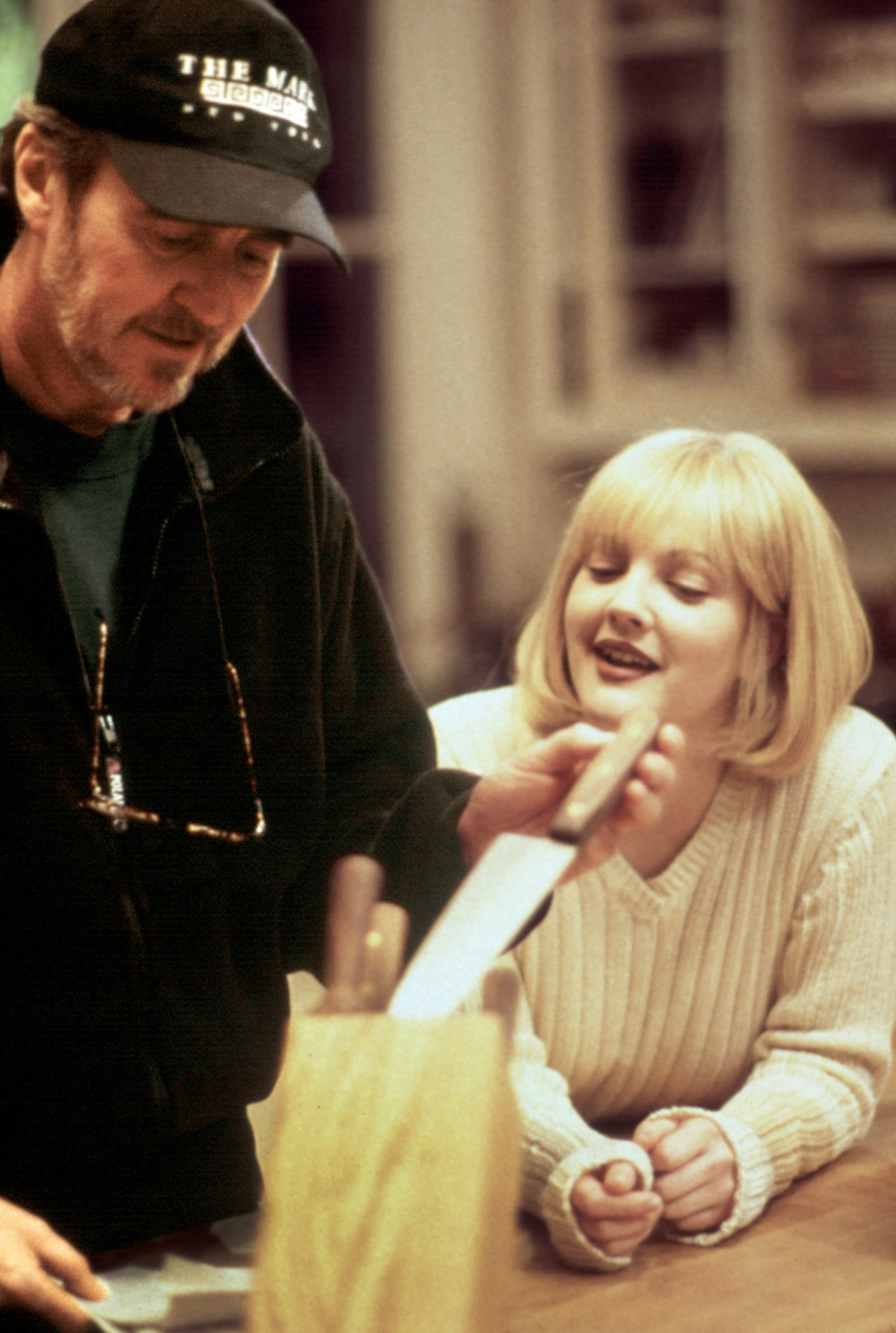 A director directs a woman in a kitchen
