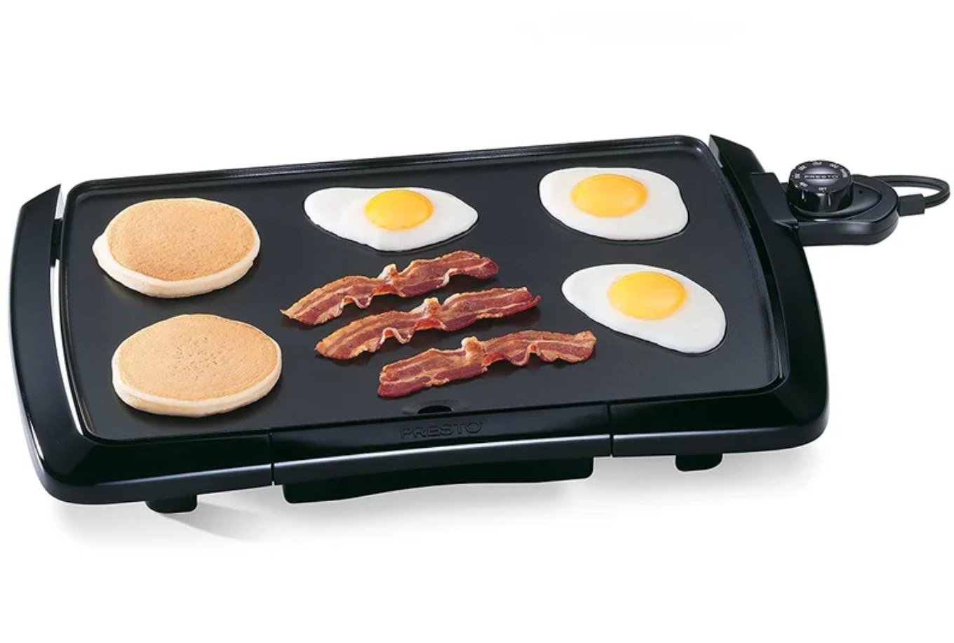 the black griddle with pancakes, bacon and eggs on it